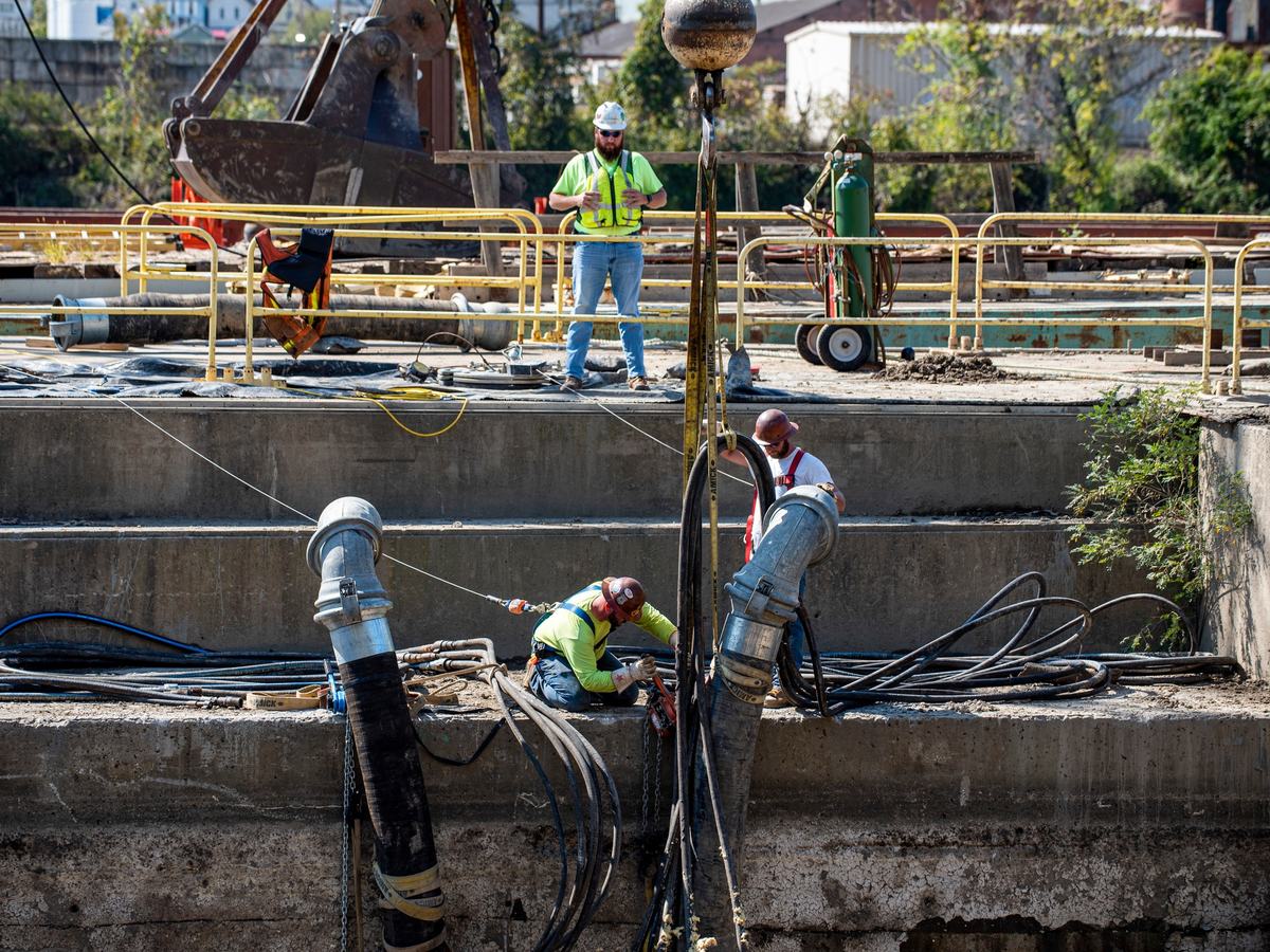 Submersible pumps and discharge hoses in an excavation
